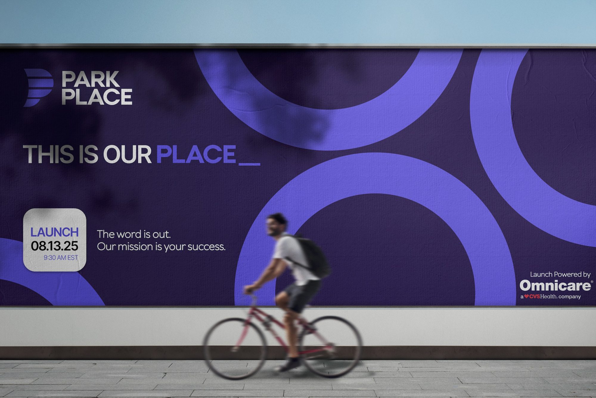 Park Place launch billboard reading This Is Our Place, with a cyclist passing
