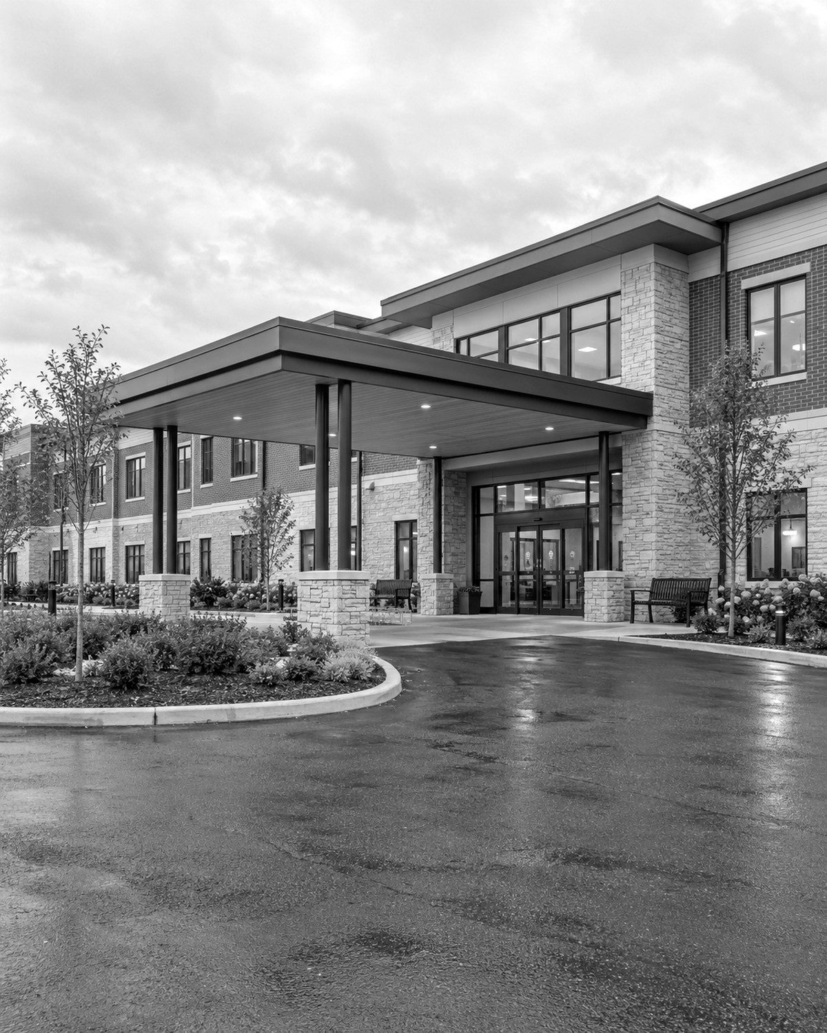 Covered entrance and drop-off canopy of a two-story skilled nursing and rehabilitation building